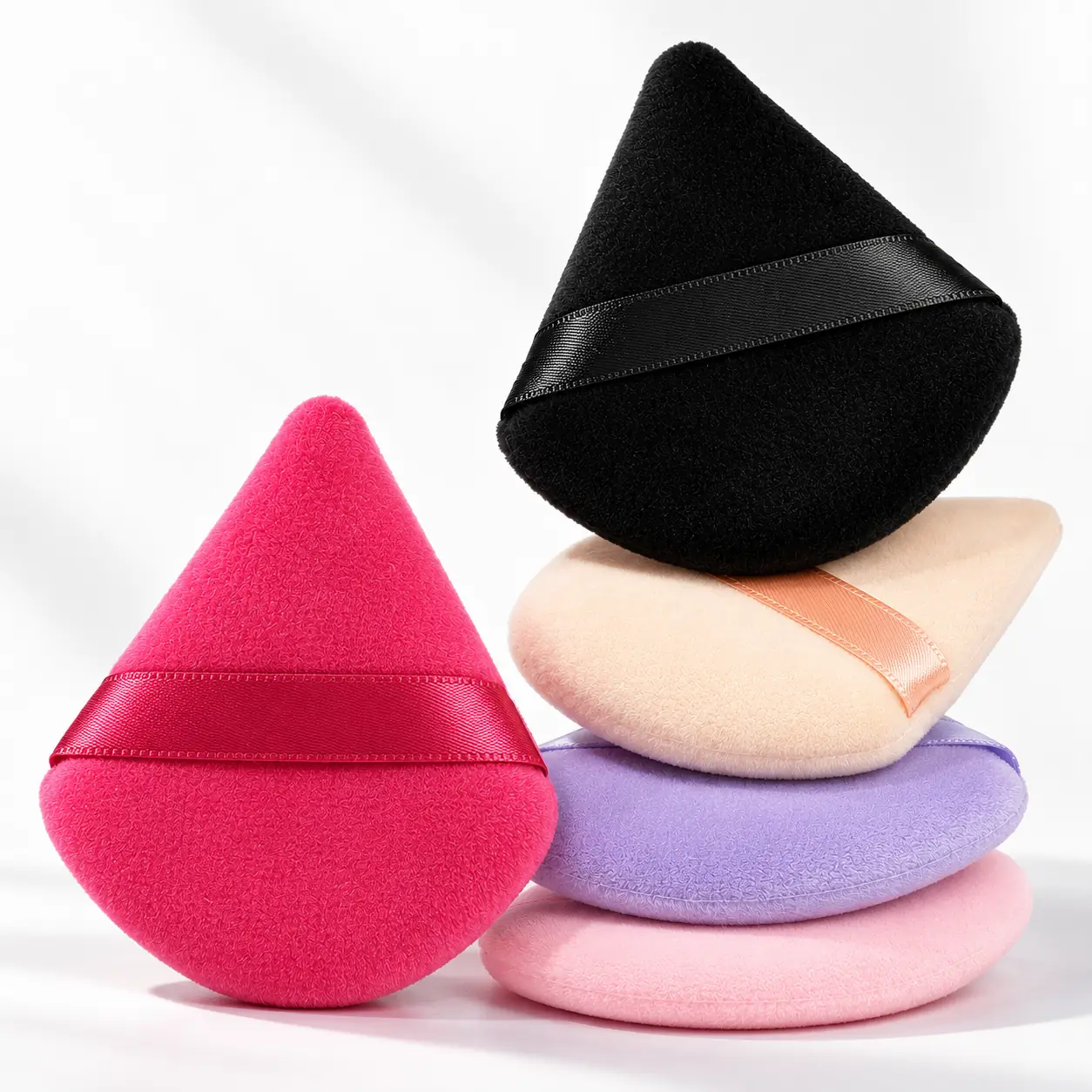 Velvet triangle powder puffs in black, cream, light pink, lavender and hot pink