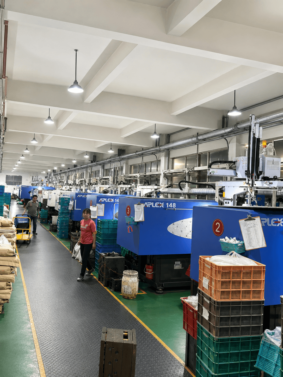 Injection molding machines and production staff at the Ningbo factory
