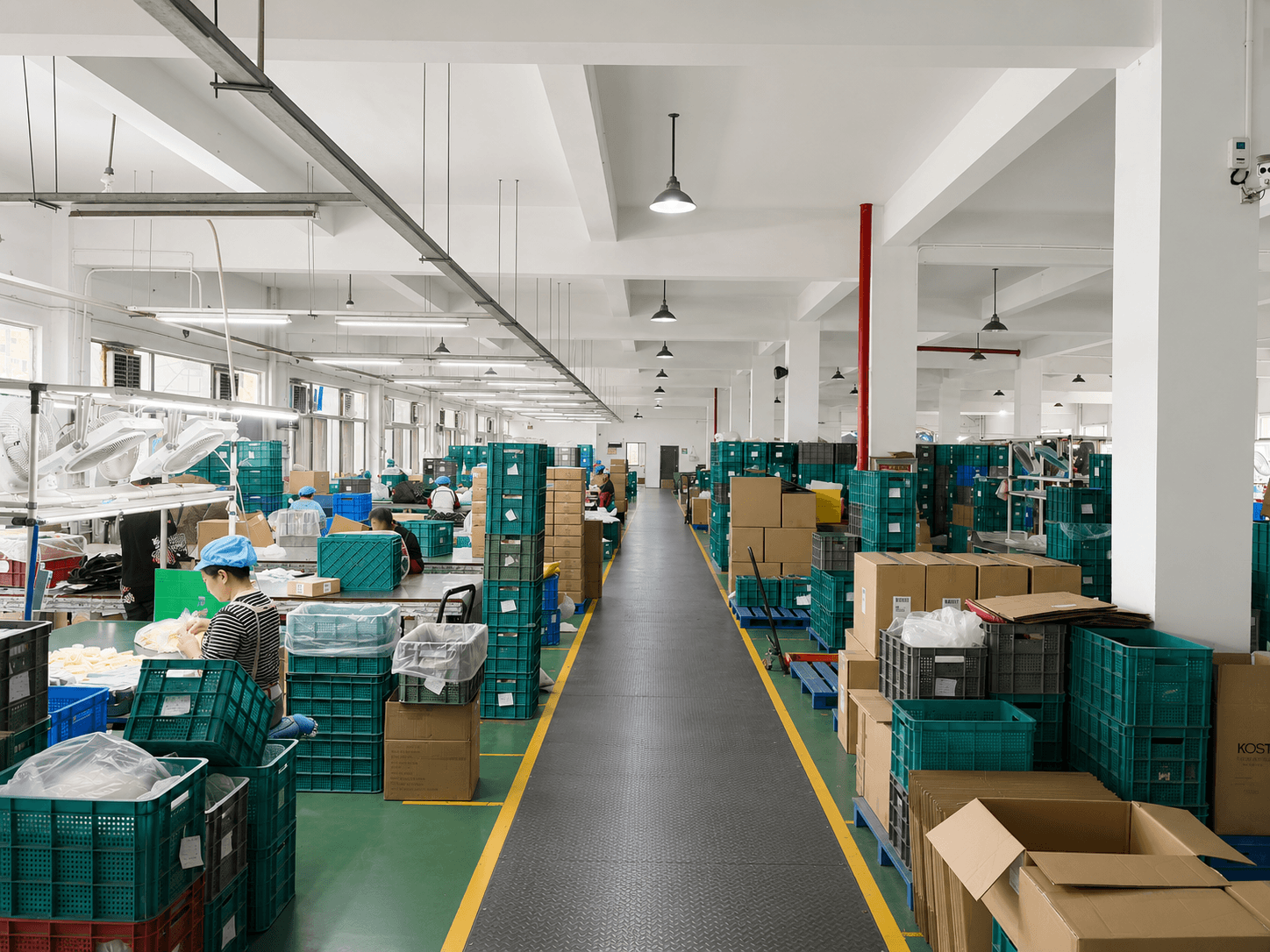 Workers and organized material bins on the main production floor at the BlendCraft factory in Ningbo