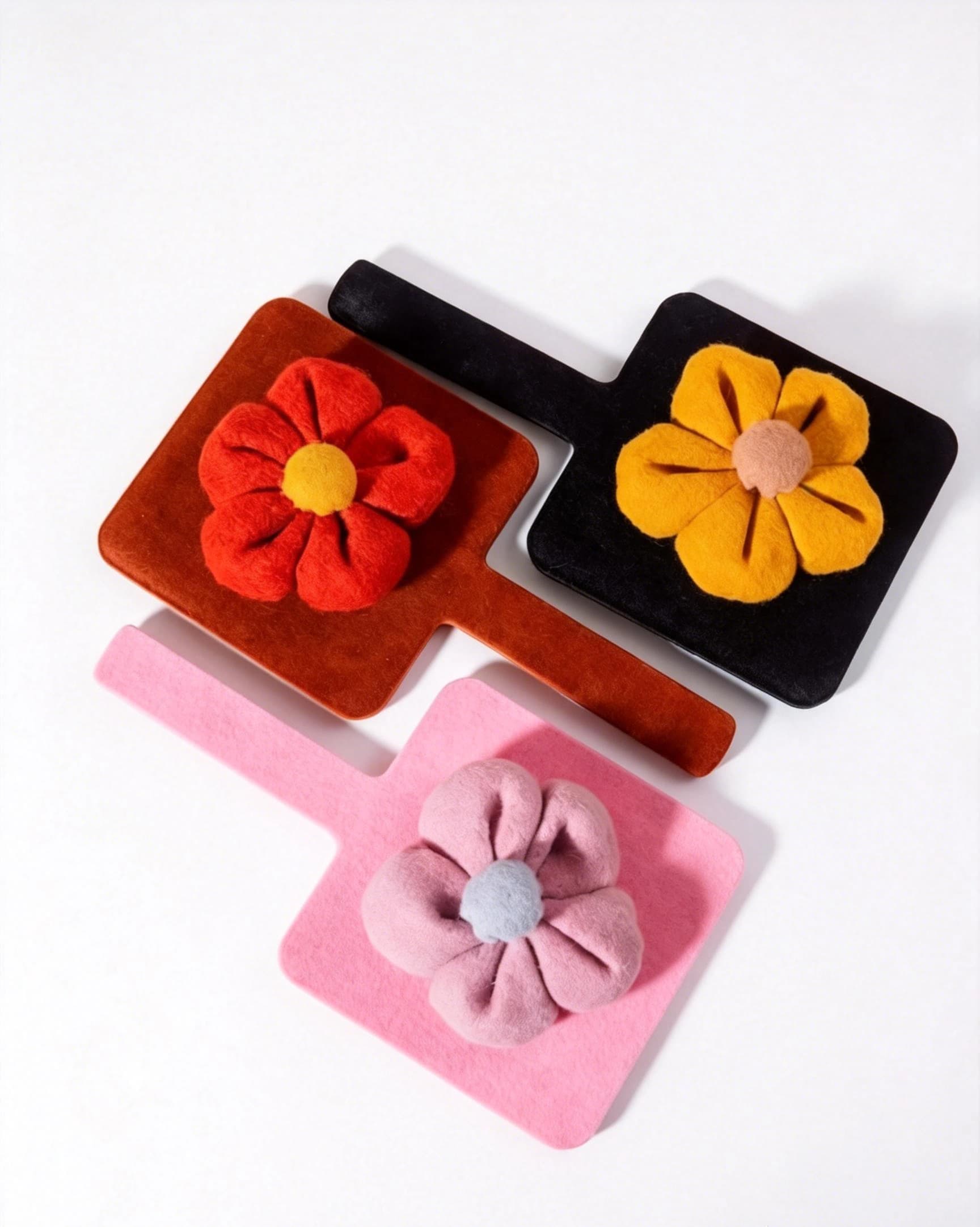 Square handheld cosmetic mirror front and fabric-covered flower back