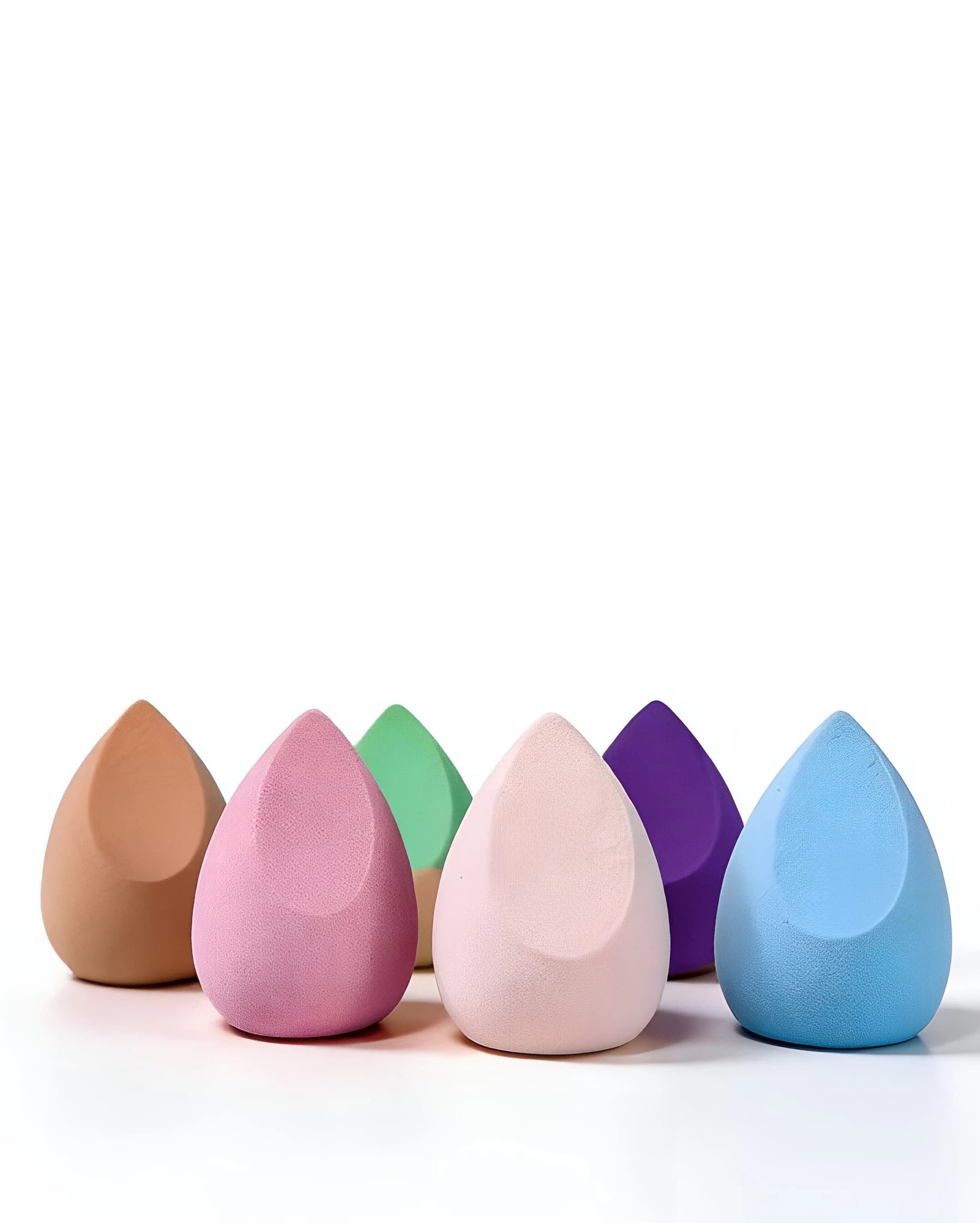 Angled makeup sponges in pink, peach, green, purple and blue with slant-cut faces