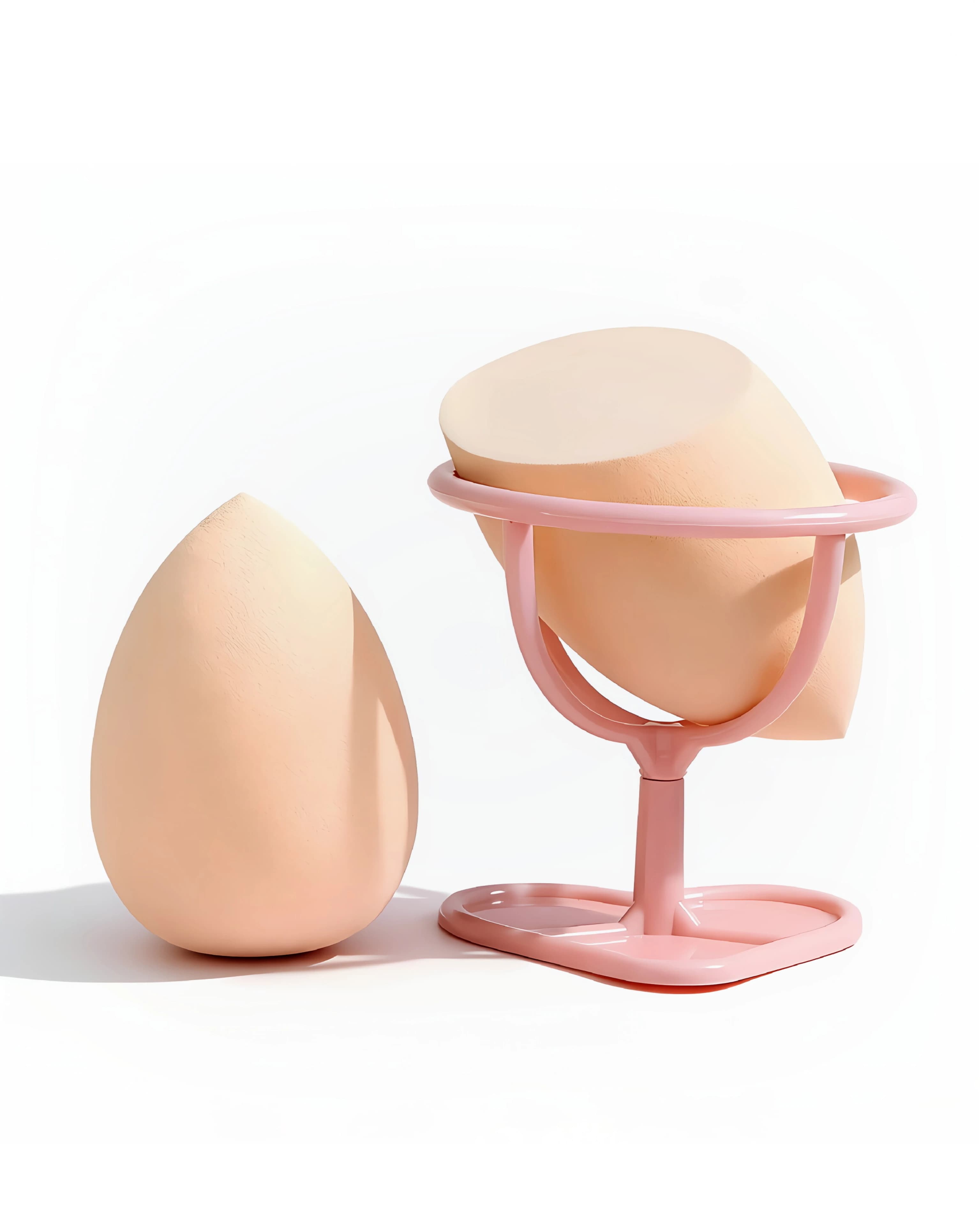 Peach angled makeup sponges beside and resting in a pink display holder