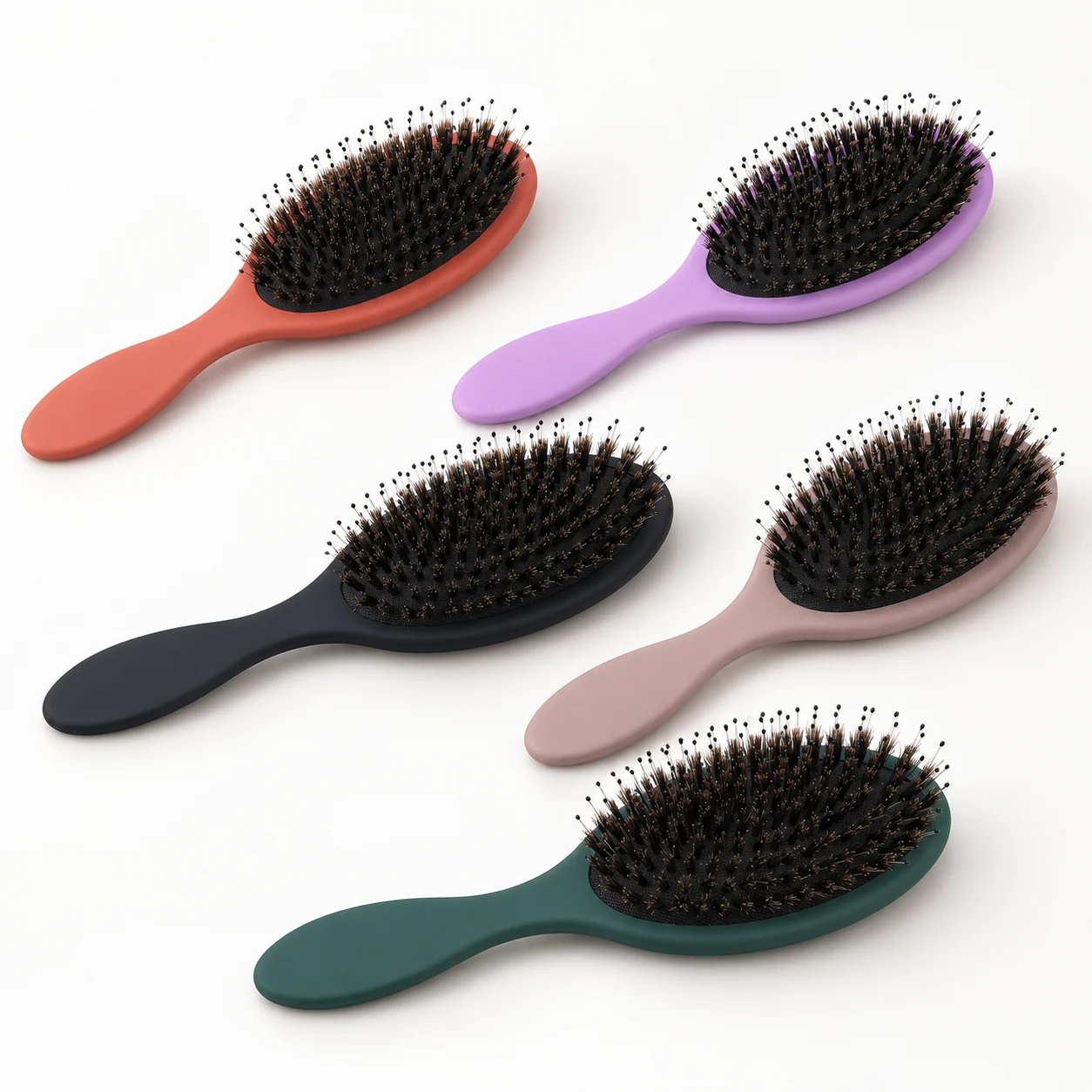 Five oval cushion brushes in assorted colors showing a mixed-bristle construction