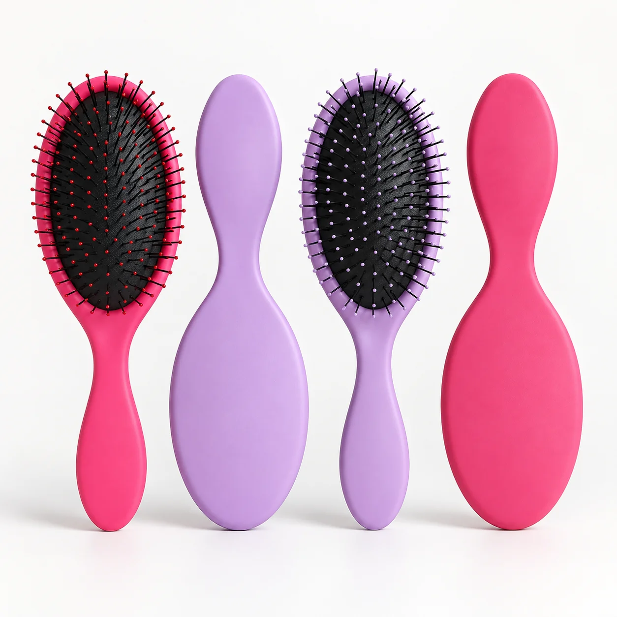 Pink and purple oval cushion brushes with the pin side and smooth back shown