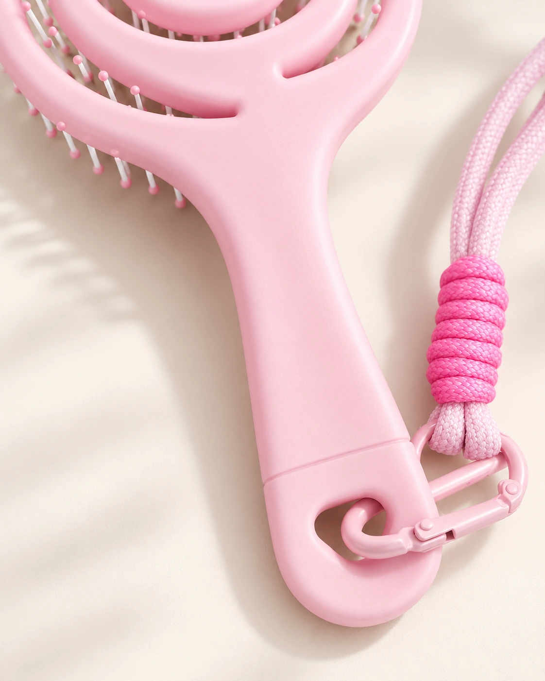 Close-up of the pink BLC-05 brush handle with its lanyard attachment and clasp