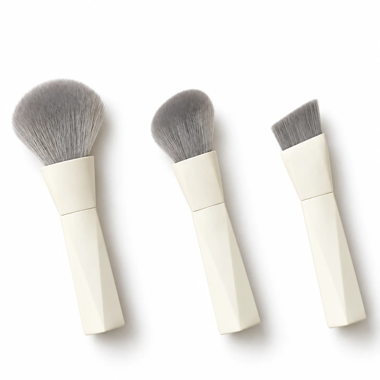 Three assembled configurations showing the powder, foundation and angled heads of an ivory magnetic makeup brush