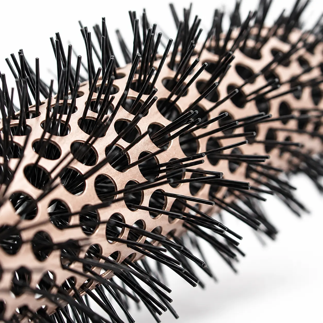 Close-up of black bristle tufts and circular vents in the champagne-colored barrel